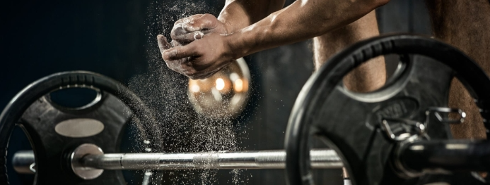 Man lifting weights in gym.